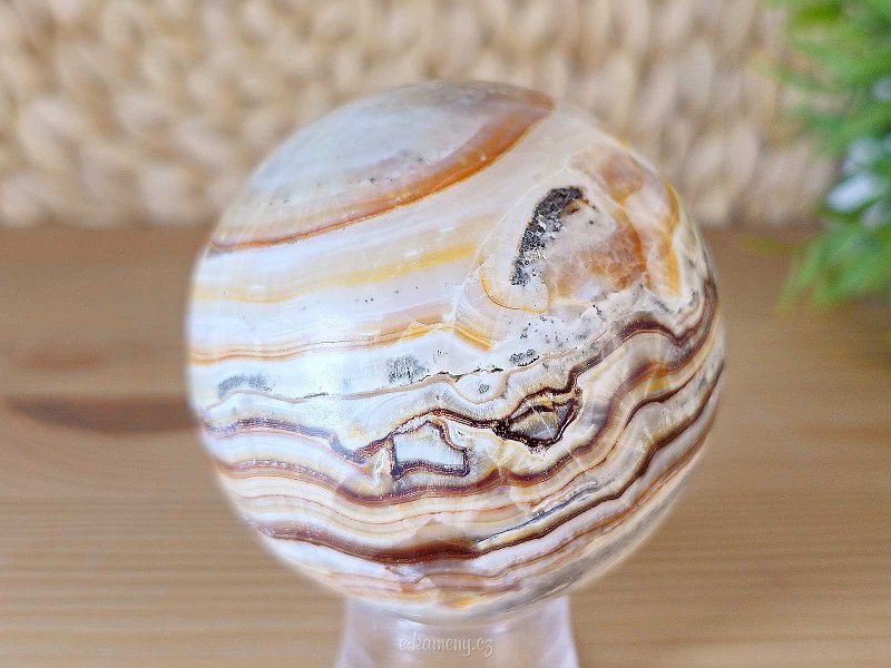 Striated aragonite stone in the shape of a ball 407 grams