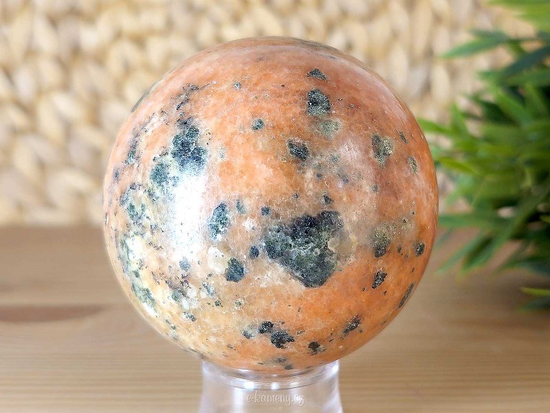 Orange calcite stone in the shape of a ball with a diameter of 6.9 cm