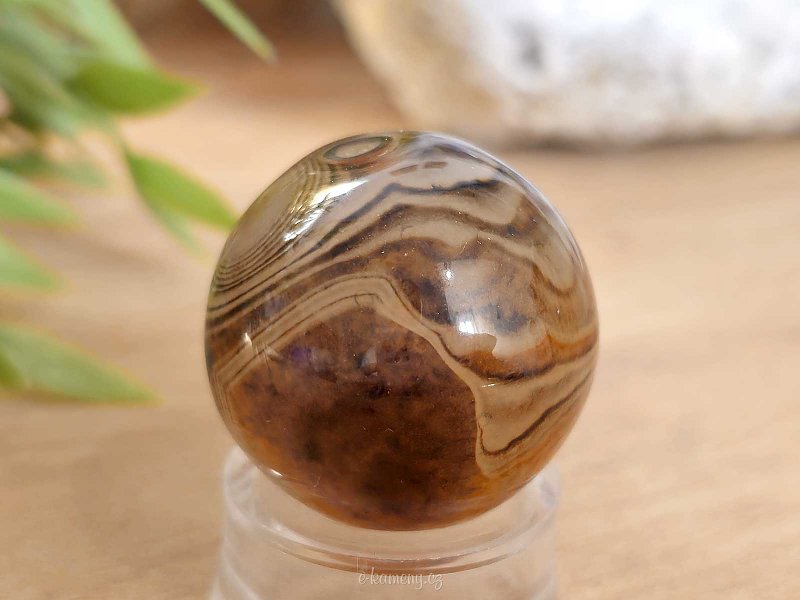 A sardonyx agate stone in the shape of a ball 47 grams