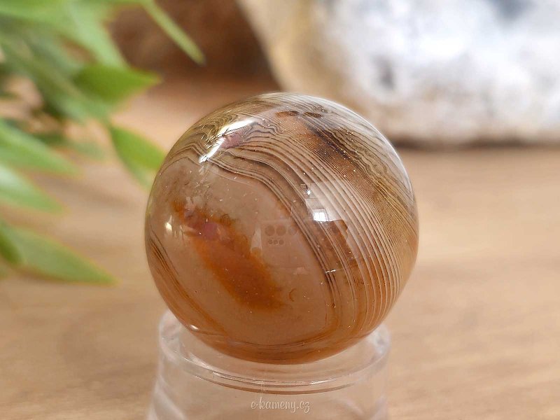 A sardonyx agate stone in the shape of a sphere 48 grams