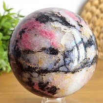 Stone in the shape of a ball of rhodonite with a diameter of 9.0 cm