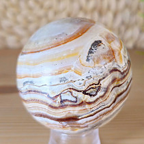Striated aragonite stone in the shape of a ball 407 grams