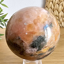 Orange calcite stone in the shape of a ball with a diameter of 8 cm