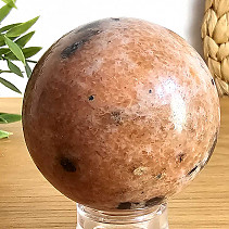 Orange calcite stone in the shape of a ball with a diameter of 5.8 cm