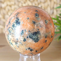 Orange calcite stone in the shape of a ball with a diameter of 6.9 cm