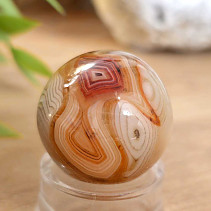 A sardonyx agate stone in the shape of a ball 38 grams