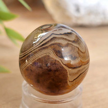 A sardonyx agate stone in the shape of a ball 47 grams