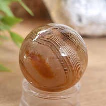 A sardonyx agate stone in the shape of a sphere 48 grams