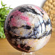 Stone in the shape of a ball of rhodonite with a diameter of 9.0 cm