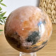 Orange calcite stone in the shape of a ball with a diameter of 8 cm