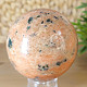 Orange calcite stone in the shape of a ball with a diameter of 6.9 cm