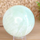 Pistachio calcite stone in the shape of a ball 473 grams