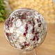 Tourmaline rubellite stone in quartz in the shape of a sphere 408 grams