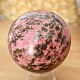 Rhodonite stone in the shape of a ball 443 grams