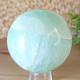 Pistachio calcite stone in the shape of a ball 843 grams